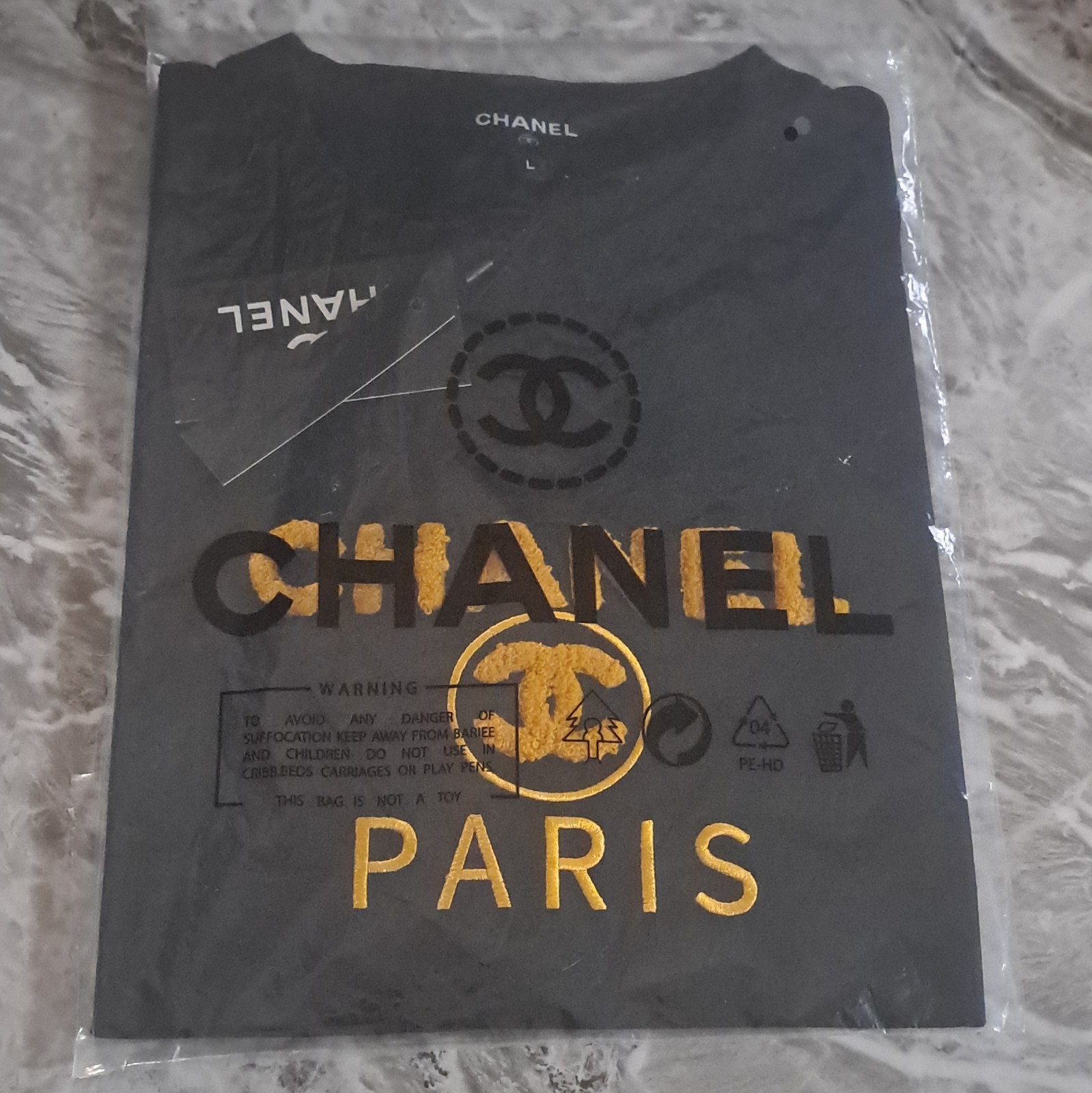 CHANEL Men’s Black Paris Logo Graphic Print Crew Neck Short Sleeve Knit Tee, L